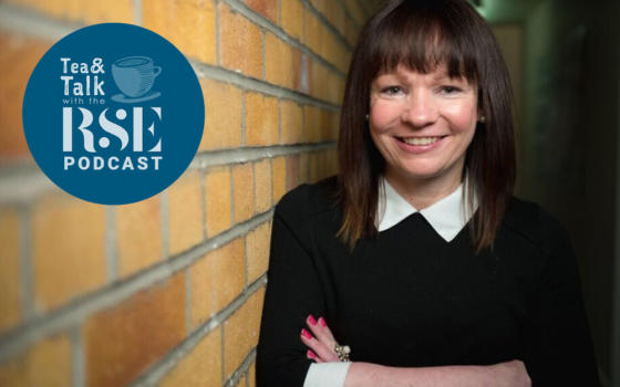 Dr. Deborah O'Neil is a female with dark brown hair and a fringe. She is stood in front of a bricked wall