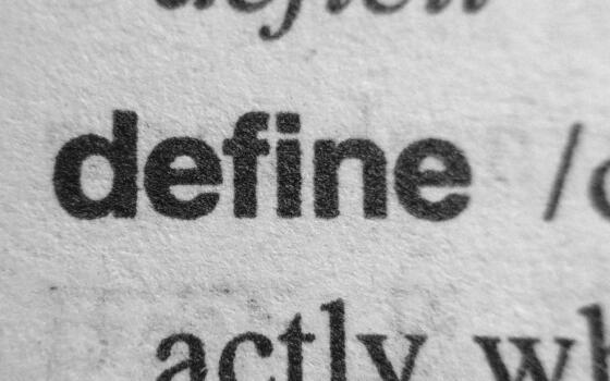 A page with words printed on it. The primary word on the page is 'define'.