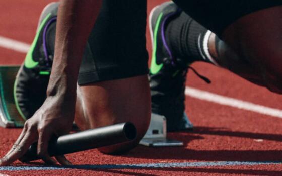 A runner is poised at the startling line